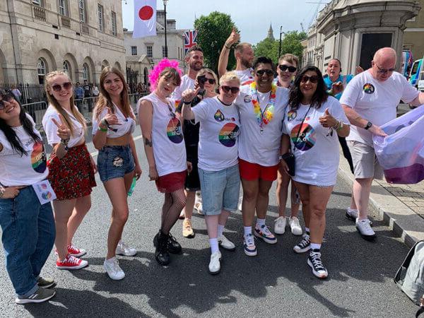 A group of Mitie colleagues at London Pride Day 2024, some wearing Mitie 'Proud to be' t-shirts